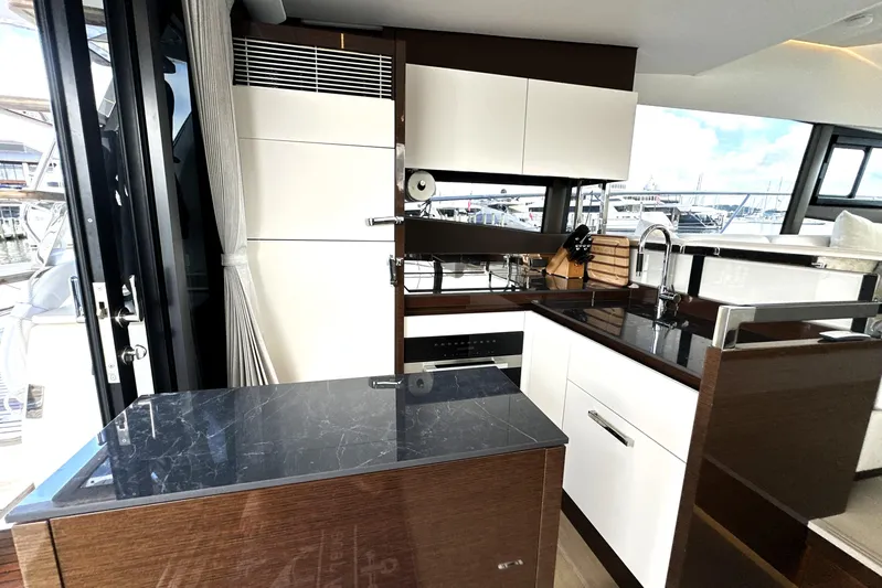 Lady Jane III Yacht Photos Pics Modern kitchen interior on 2023 Prestige 520 yacht, featuring sleek cabinetry and appliances.
