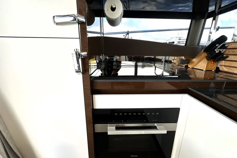 Lady Jane III Yacht Photos Pics Modern kitchen interior on 2023 Prestige 520 yacht, featuring sleek appliances and elegant design.