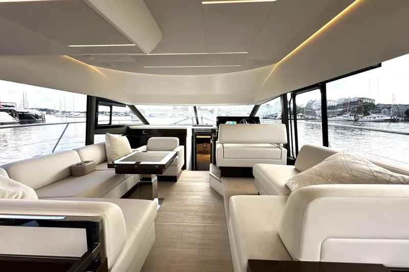 Lady Jane III Yacht Photos Pics Luxurious interior of 2023 Prestige 520 yacht with elegant seating and panoramic windows.
