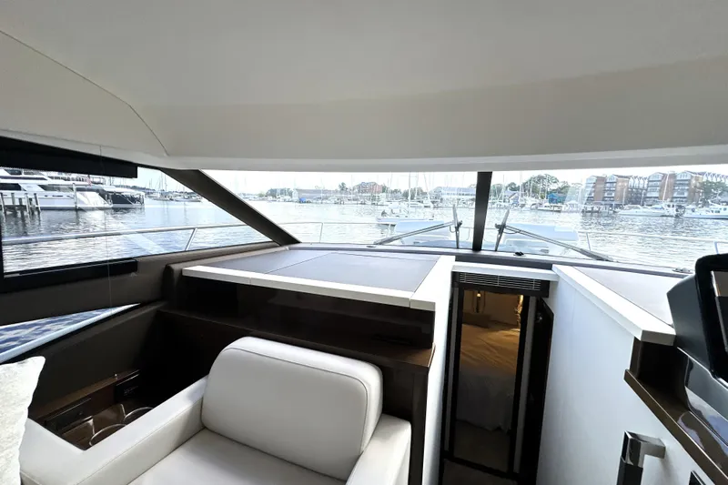 Lady Jane III Yacht Photos Pics Interior view of 2023 Prestige 520 yacht with marina backdrop.