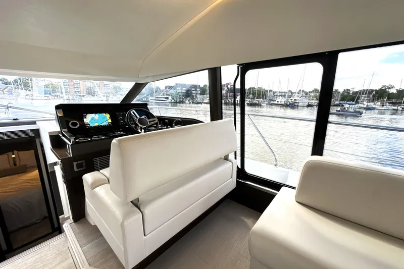 Lady Jane III Yacht Photos Pics Luxurious interior of 2023 Prestige 520 yacht with modern helm and marina view.