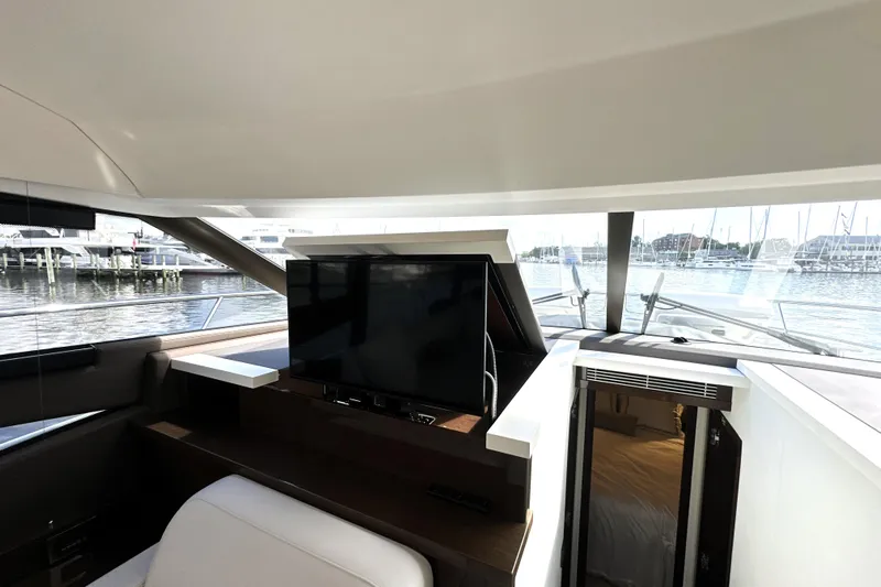 Lady Jane III Yacht Photos Pics Luxurious interior of 2023 Prestige 520 yacht with TV and waterfront view.