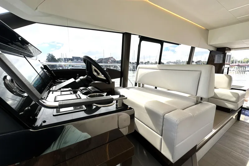 Lady Jane III Yacht Photos Pics Luxurious interior of 2023 Prestige 520 yacht with modern helm and white seating.
