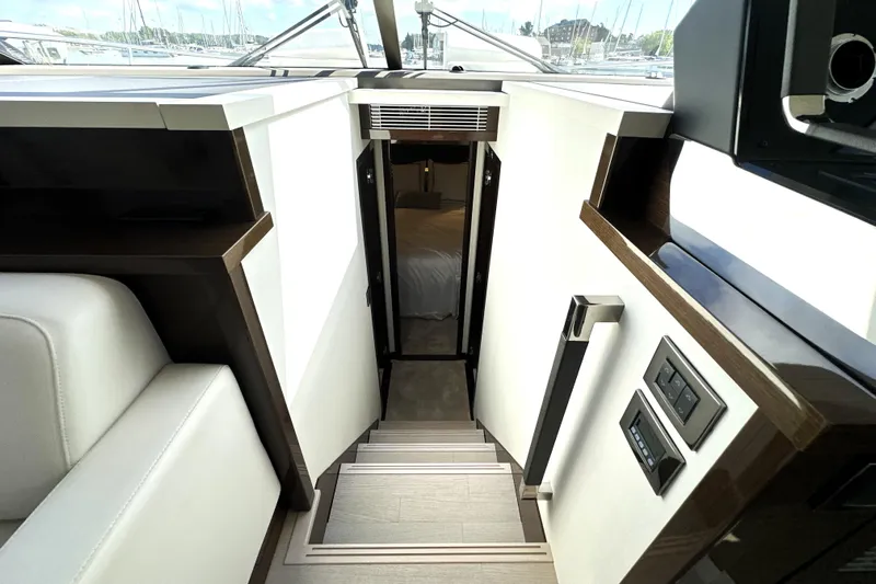 Lady Jane III Yacht Photos Pics Stairway leading to cabin interior of 2023 Prestige 520 yacht, featuring modern design elements.