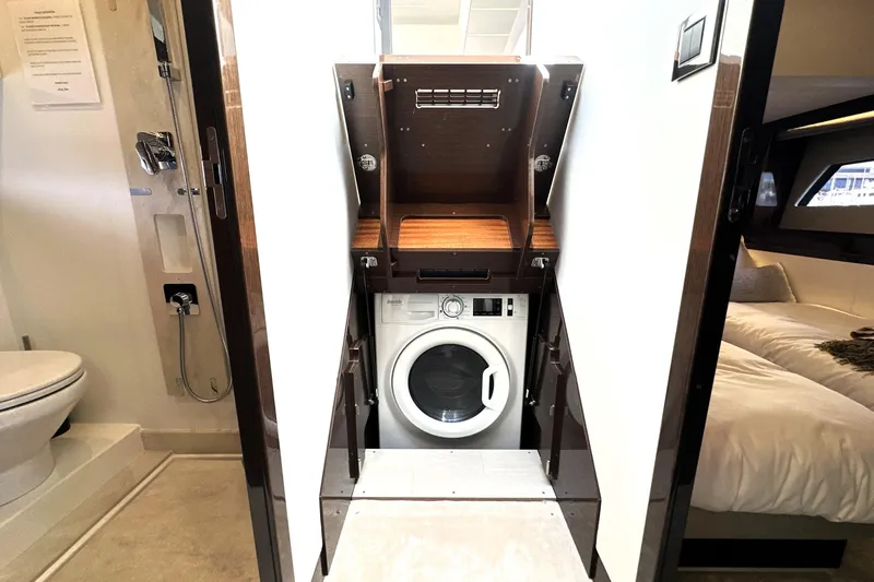 Lady Jane III Yacht Photos Pics 2023 Prestige 520 yacht interior with washing machine, bathroom, and bedroom.