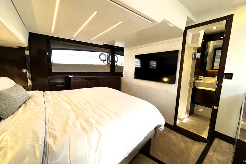 Lady Jane III Yacht Photos Pics Luxurious bedroom interior of 2023 Prestige 520 yacht with modern amenities and elegant design.