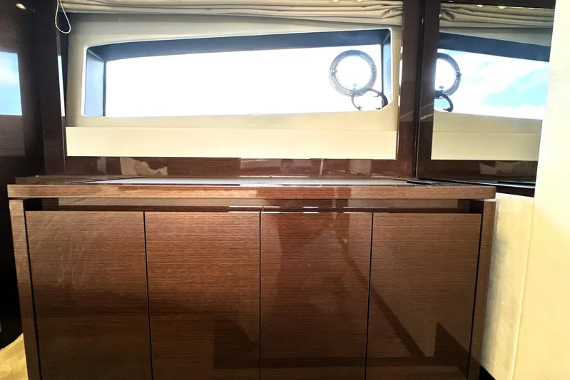 Lady Jane III Yacht Photos Pics Luxurious interior of 2023 Prestige 520 yacht with sleek wooden cabinetry and large windows.