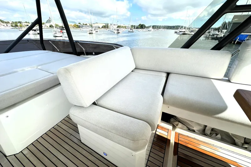 Lady Jane III Yacht Photos Pics Luxurious seating on 2023 Prestige 520 yacht with scenic marina view.