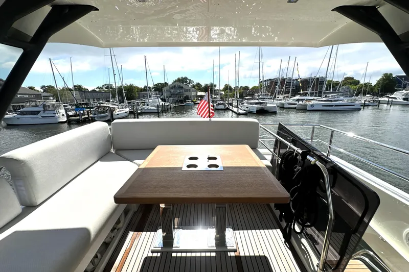 Lady Jane III Yacht Photos Pics Luxurious 2023 Prestige 520 yacht interior with marina view, featuring elegant seating and table.