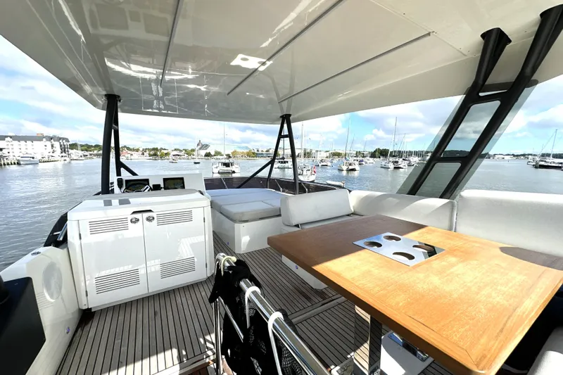 Lady Jane III Yacht Photos Pics Luxurious 2023 Prestige 520 yacht interior with elegant seating and scenic marina view.