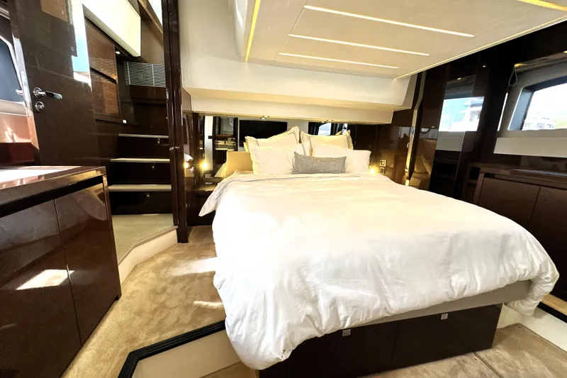 Lady Jane III Yacht Photos Pics Luxurious bedroom interior of 2023 Prestige 520 yacht with elegant bedding and modern design.