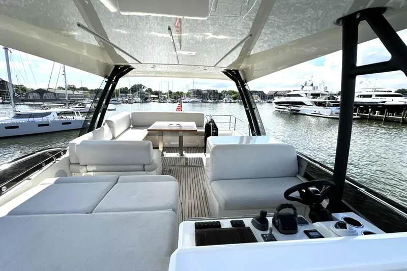 Lady Jane III Yacht Photos Pics Luxurious 2023 Prestige 520 yacht interior with spacious seating and scenic marina view.