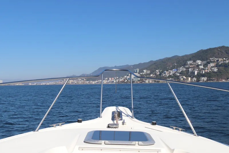 La Ultima Chica Yacht Photos Pics 1997 Tiara Yachts Express cruising on open water with coastal view.