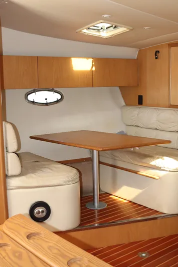 La Ultima Chica Yacht Photos Pics 1997 Tiara Yachts Express interior with wooden table and leather seating.