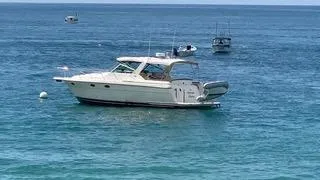 La Ultima Chica Yacht Photos Pics 1997 Tiara Yachts Express boat anchored on calm blue ocean waters.