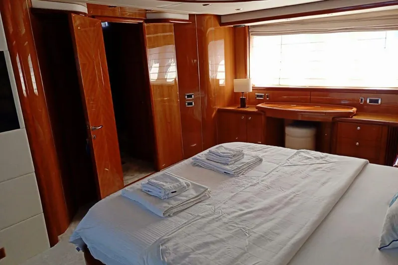  Yacht Photos Pics Luxurious bedroom interior of 2005 Sunseeker 94 Yacht with elegant wood finishes.