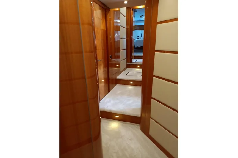  Yacht Photos Pics Luxurious wooden interior hallway of 2005 Sunseeker 94 Yacht, featuring elegant lighting.