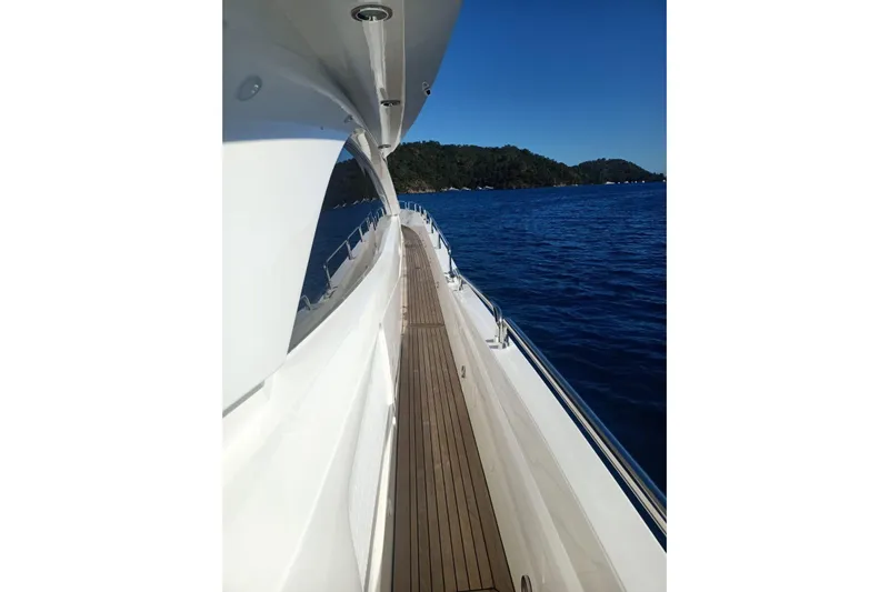  Yacht Photos Pics Side view of 2005 Sunseeker 94 Yacht on calm blue sea.