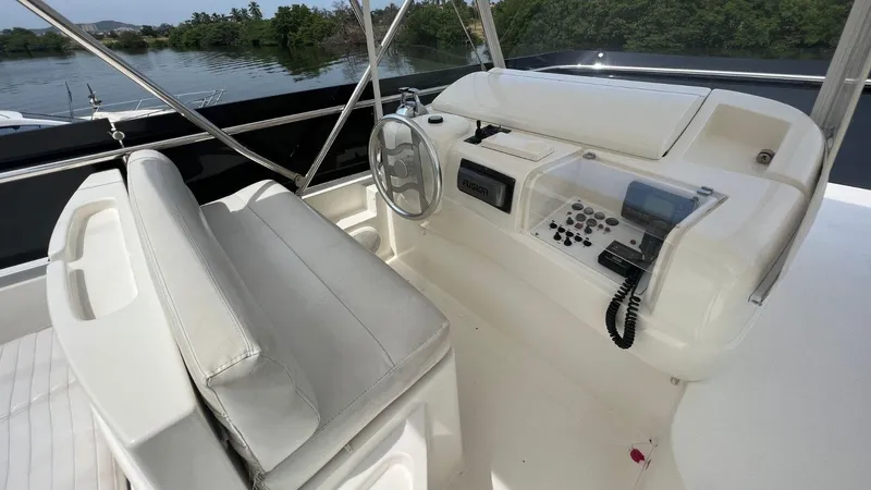 Etan Yacht Photos Pics Helm station of 2004 Ferretti Yachts 760 with white seating and control panel.