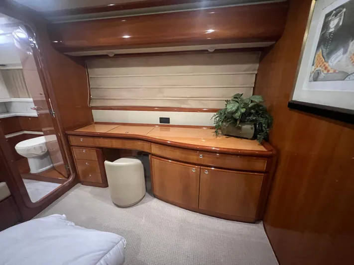 Etan Yacht Photos Pics Luxurious cabin interior of 2004 Ferretti Yachts 760 with wooden desk and cabinetry.