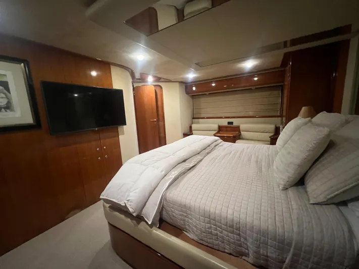Etan Yacht Photos Pics Luxurious bedroom in a 2004 Ferretti Yachts 760 with modern amenities and elegant design.