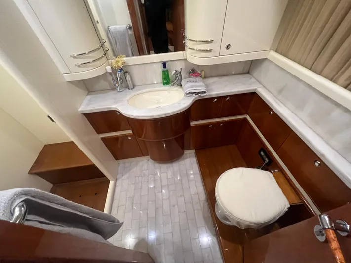 Etan Yacht Photos Pics Luxurious bathroom in a 2004 Ferretti Yachts 760 with elegant wood and marble finishes.