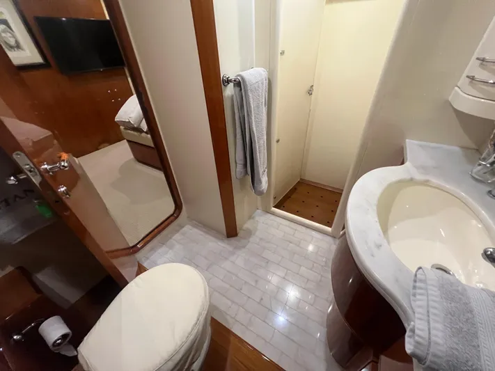 Etan Yacht Photos Pics Bathroom interior of a 2004 Ferretti Yachts 760, featuring a sink, toilet, and shower.