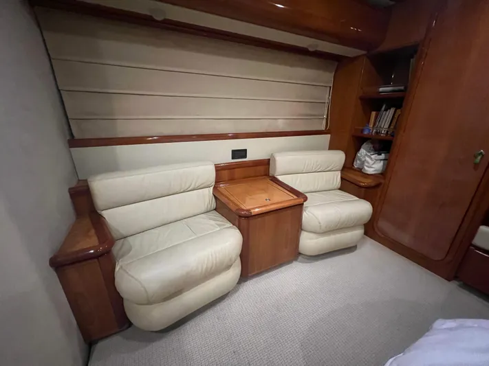 Etan Yacht Photos Pics Luxurious seating area in a 2004 Ferretti Yachts 760 with beige leather chairs and wooden accents.