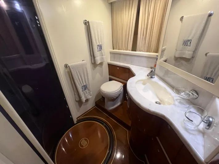 Etan Yacht Photos Pics Luxurious bathroom in a 2004 Ferretti Yachts 760, featuring elegant fixtures and wooden accents.