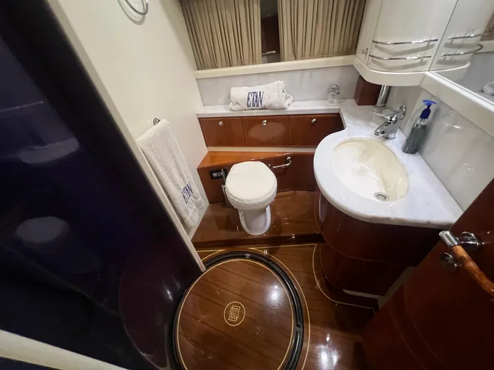 Etan Yacht Photos Pics Luxurious bathroom in a 2004 Ferretti Yachts 760 with elegant wood finishes.