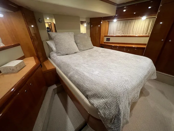 Etan Yacht Photos Pics Luxurious bedroom interior of 2004 Ferretti Yachts 760 with cozy bed and wooden cabinetry.