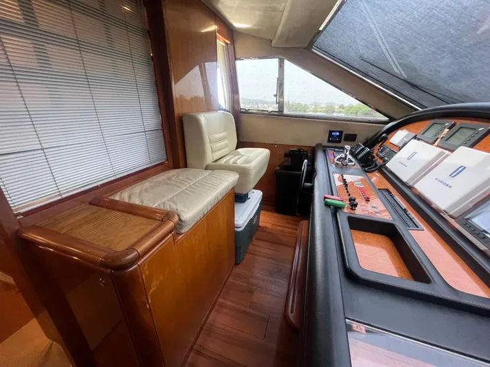 Etan Yacht Photos Pics Interior helm station of 2004 Ferretti Yachts 760 with leather seating and wooden finishes.