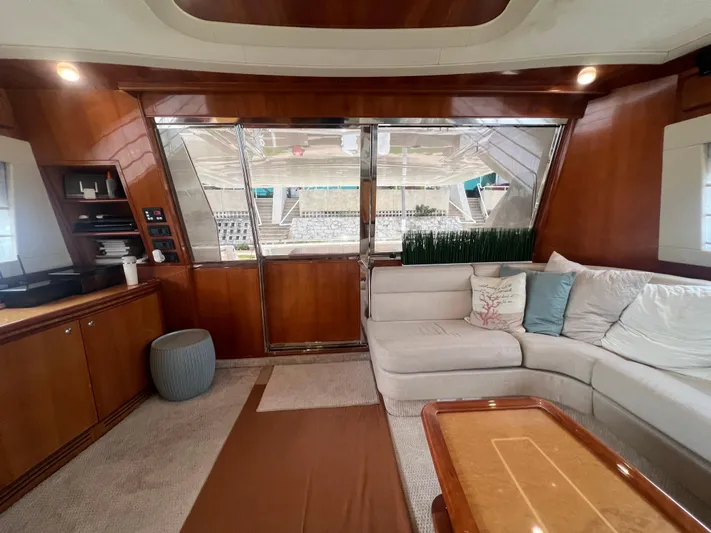 Etan Yacht Photos Pics Luxurious interior of a 2004 Ferretti Yachts 760 with plush seating and wooden accents.