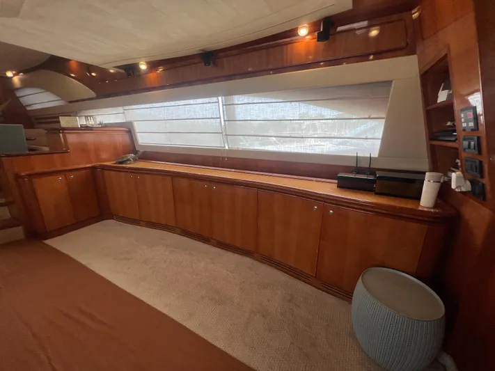 Etan Yacht Photos Pics Luxurious interior of a 2004 Ferretti Yachts 760 with wooden cabinetry and large windows.
