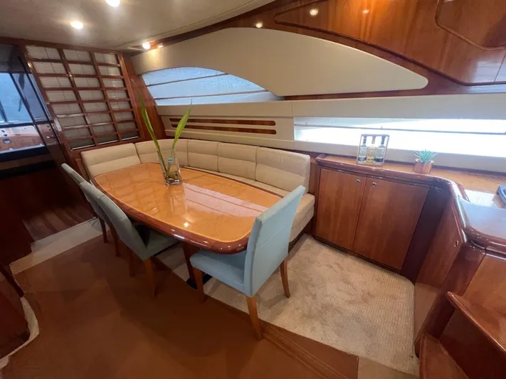 Etan Yacht Photos Pics Luxurious dining area on a 2004 Ferretti Yachts 760 with elegant wood finishes.