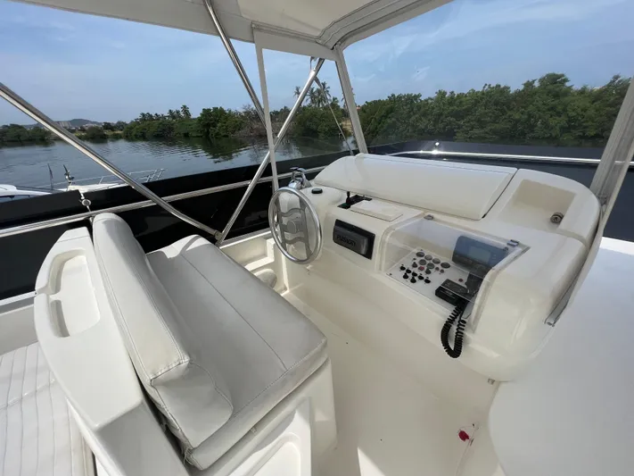 Etan Yacht Photos Pics Helm station of 2004 Ferretti Yachts 760 with dual seating and control panel.