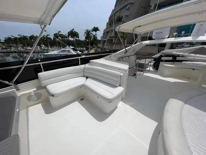Etan Yacht Photos Pics Flybridge seating area on a 2004 Ferretti Yachts 760, docked at a marina.