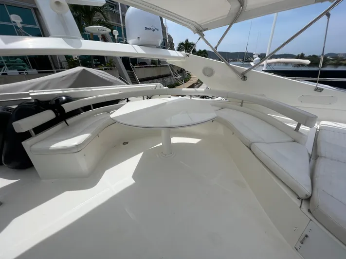 Etan Yacht Photos Pics 2004 Ferretti Yachts 760 flybridge seating area with white cushions and table.