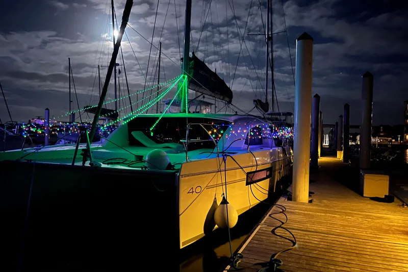 Changing Keys Yacht Photos Pics 2020 Leopard 40 catamaran adorned with colorful lights at night dockside.