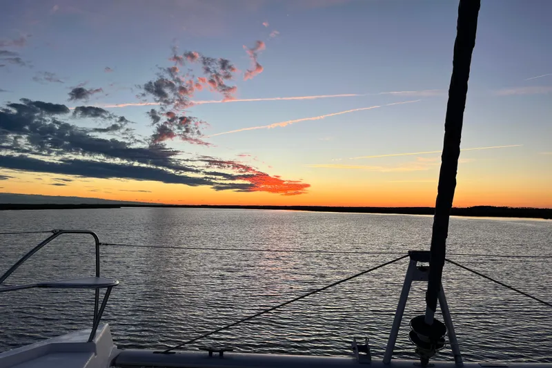 Changing Keys Yacht Photos Pics Sailing on a 2020 Leopard 40 catamaran at sunset, tranquil waters and vibrant sky.