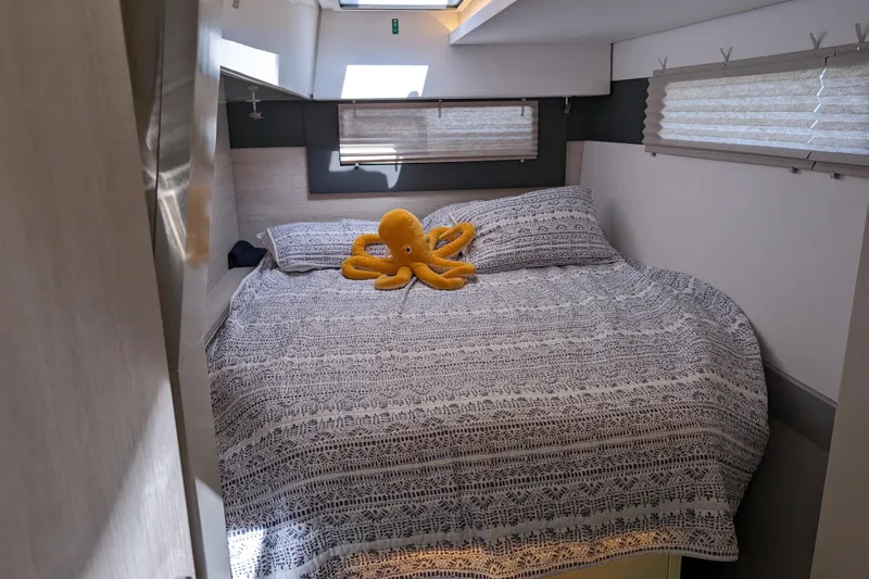 Changing Keys Yacht Photos Pics Cozy cabin bedroom in 2020 Leopard 40 yacht with patterned bedding and plush octopus toy.