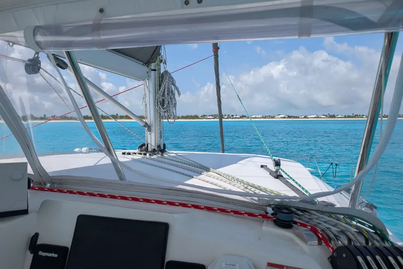 Changing Keys Yacht Photos Pics Leopard 40 catamaran sailing in turquoise waters near a sandy beach, 2020 model.