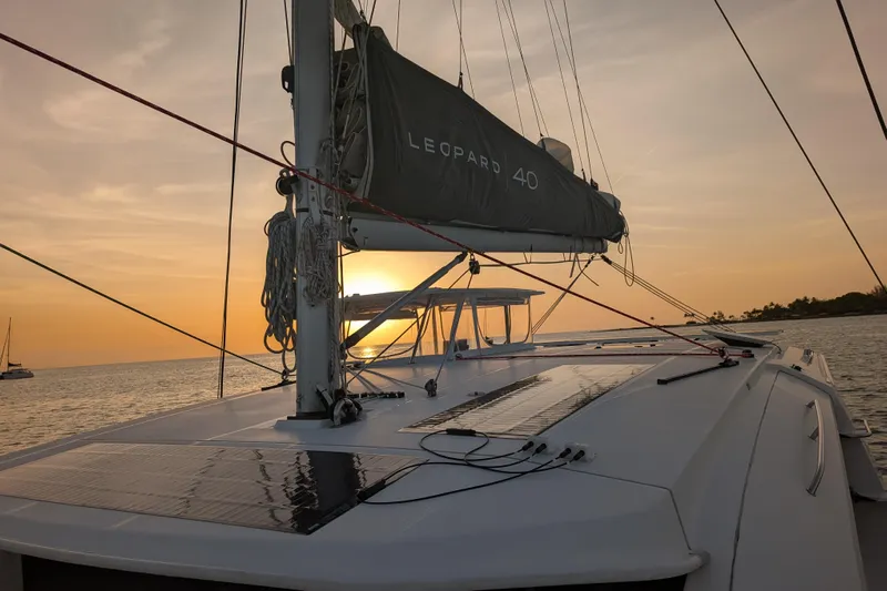 Changing Keys Yacht Photos Pics Leopard 40 catamaran sailing at sunset, 2020 model, with scenic ocean view.
