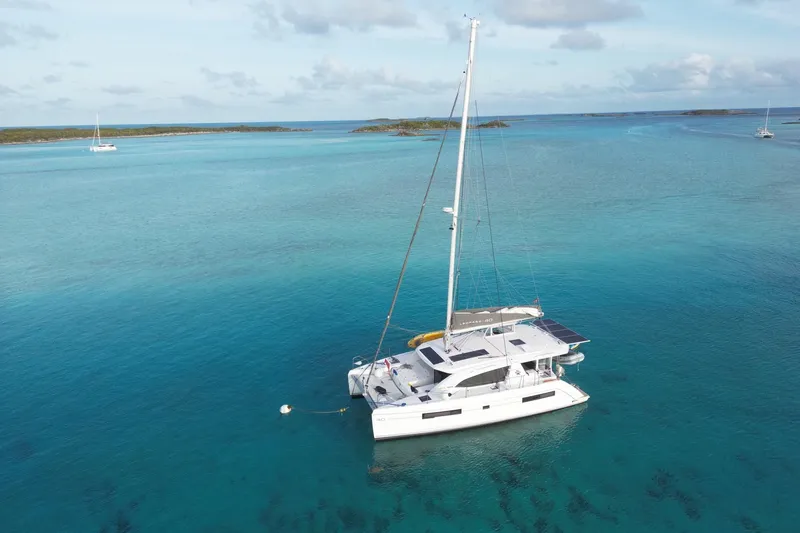 Changing Keys Yacht Photos Pics Aerial view of 2020 Leopard 40 catamaran sailing in clear turquoise waters.