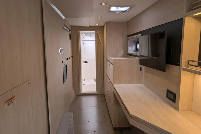 Changing Keys Yacht Photos Pics Modern interior of a 2020 Leopard 40 yacht, featuring sleek wood finishes and a mounted TV.