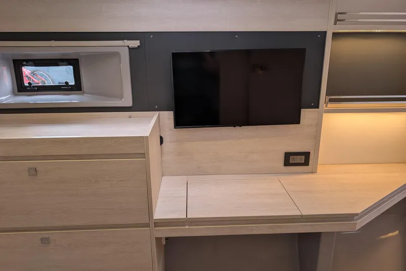 Changing Keys Yacht Photos Pics Modern interior of Leopard 40 yacht, featuring TV, window, and sleek cabinetry, 2020 model.