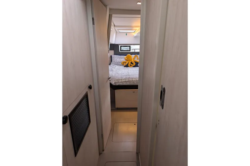 Changing Keys Yacht Photos Pics Narrow hallway leading to a cozy bedroom in a 2020 Leopard 40 catamaran.