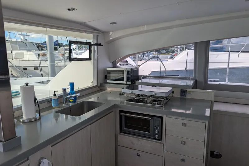 Changing Keys Yacht Photos Pics Modern kitchen interior on a 2020 Leopard 40 yacht with appliances and marina view.
