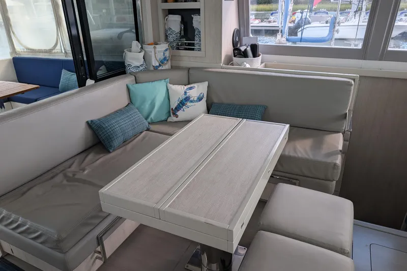 Changing Keys Yacht Photos Pics Cozy interior of 2020 Leopard 40 catamaran with cushioned seating and nautical decor.