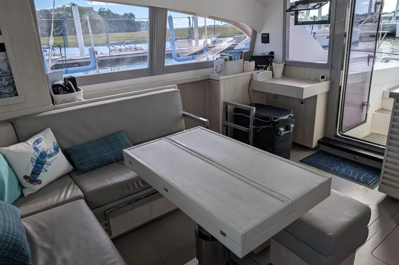 Changing Keys Yacht Photos Pics Modern interior of a 2020 Leopard 40 catamaran with comfortable seating and a scenic marina view.